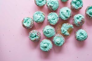 mint green cupcakes with rainbows candies